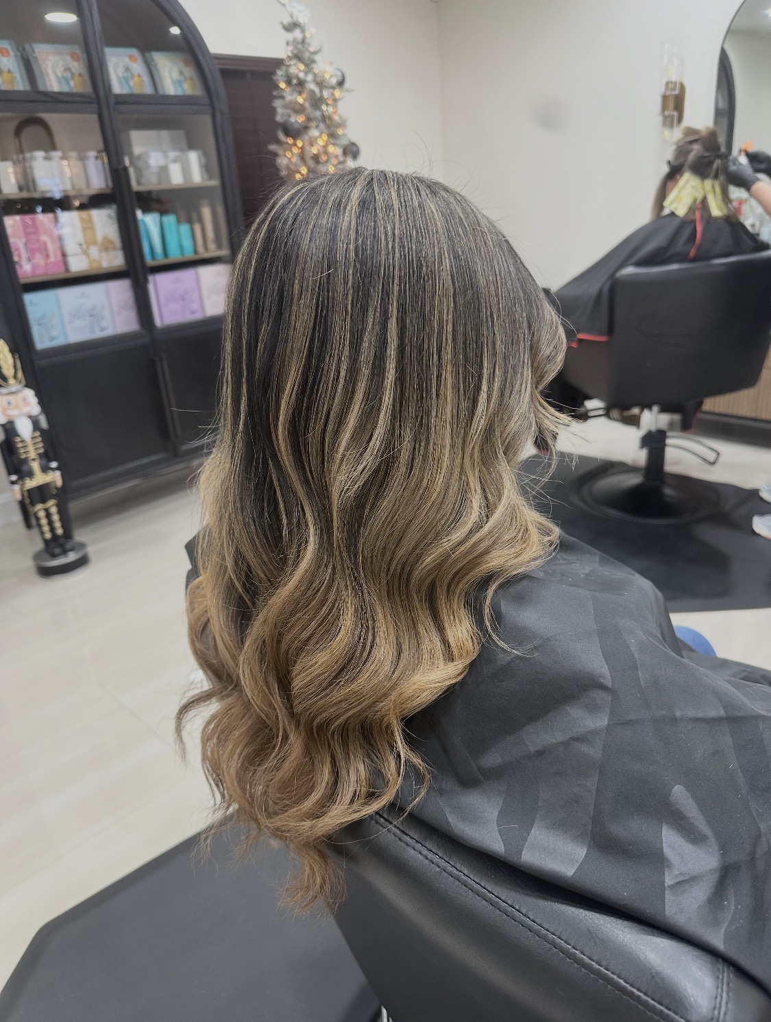 After: soft, blended balayage with toned, styled waves