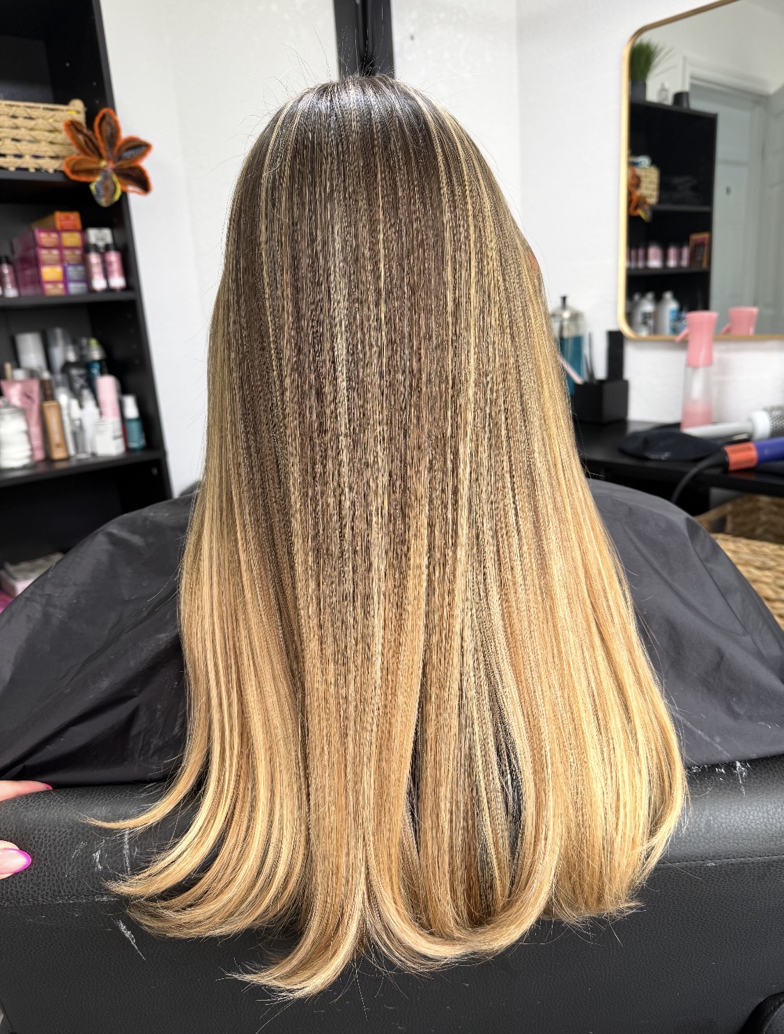 After: fine, blended highlights toned to a soft beige blonde with a smooth blowout