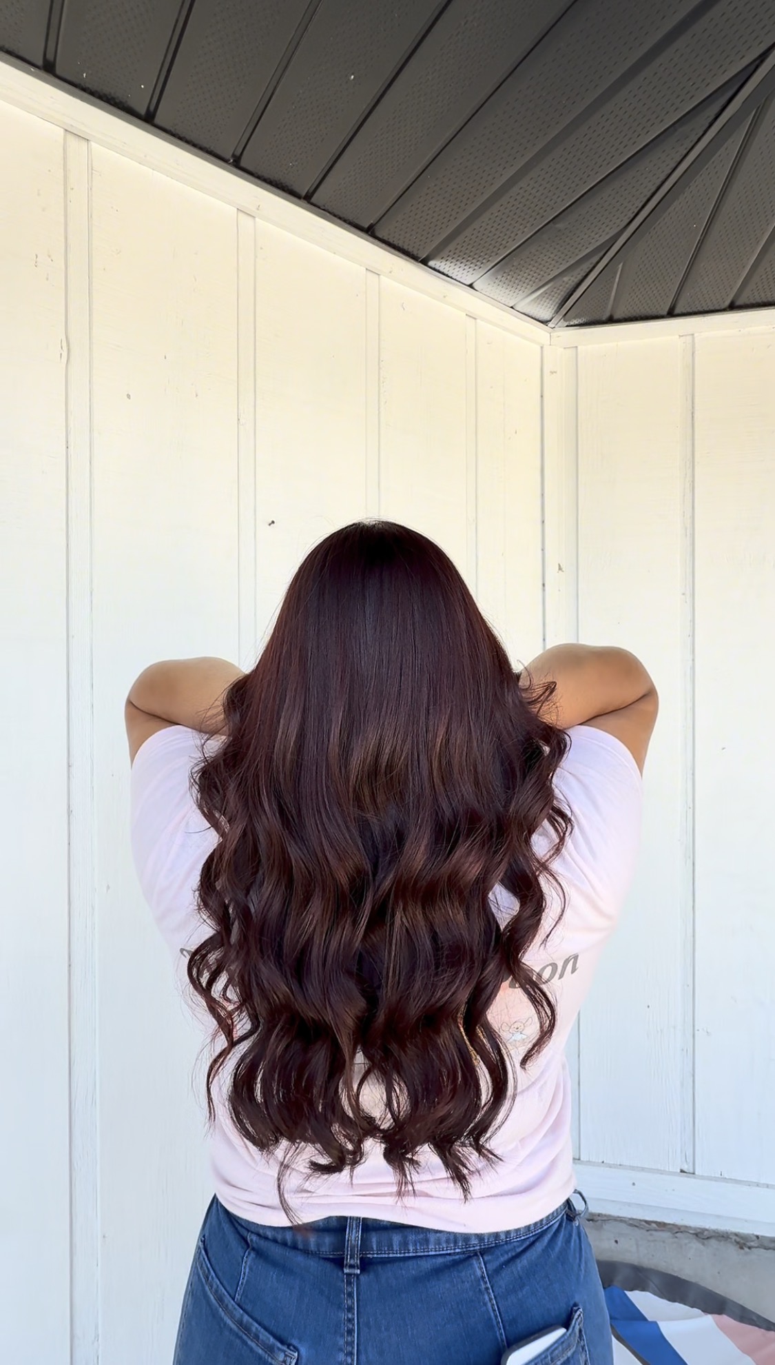 After: rich, glossy mahogany brunette with soft, styled waves